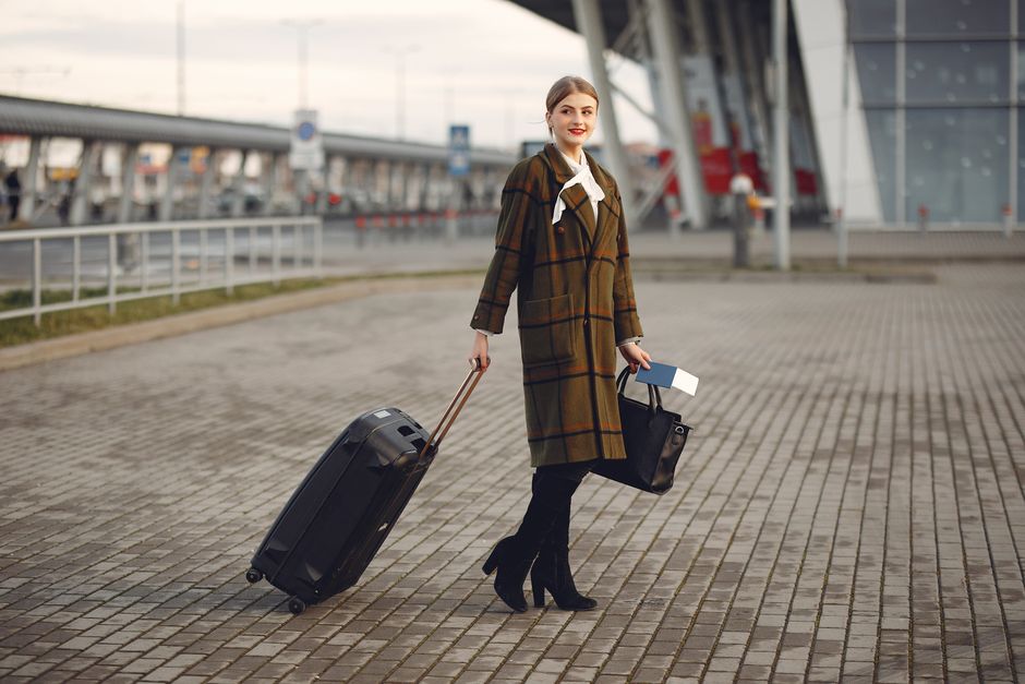 A traveler at airport security with a crossbody bag open, revealing passport and wallet, emphasizing quick access and security.