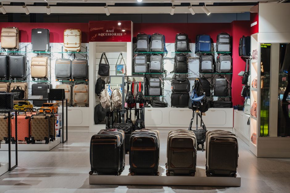 An assortment of different carry-on bags, including hardshell, softshell, and travel backpacks, against a simple background.